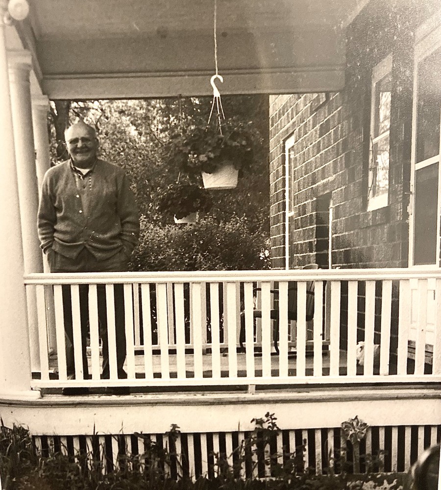 Joe Makowiec standing on his porch watching a family member leave