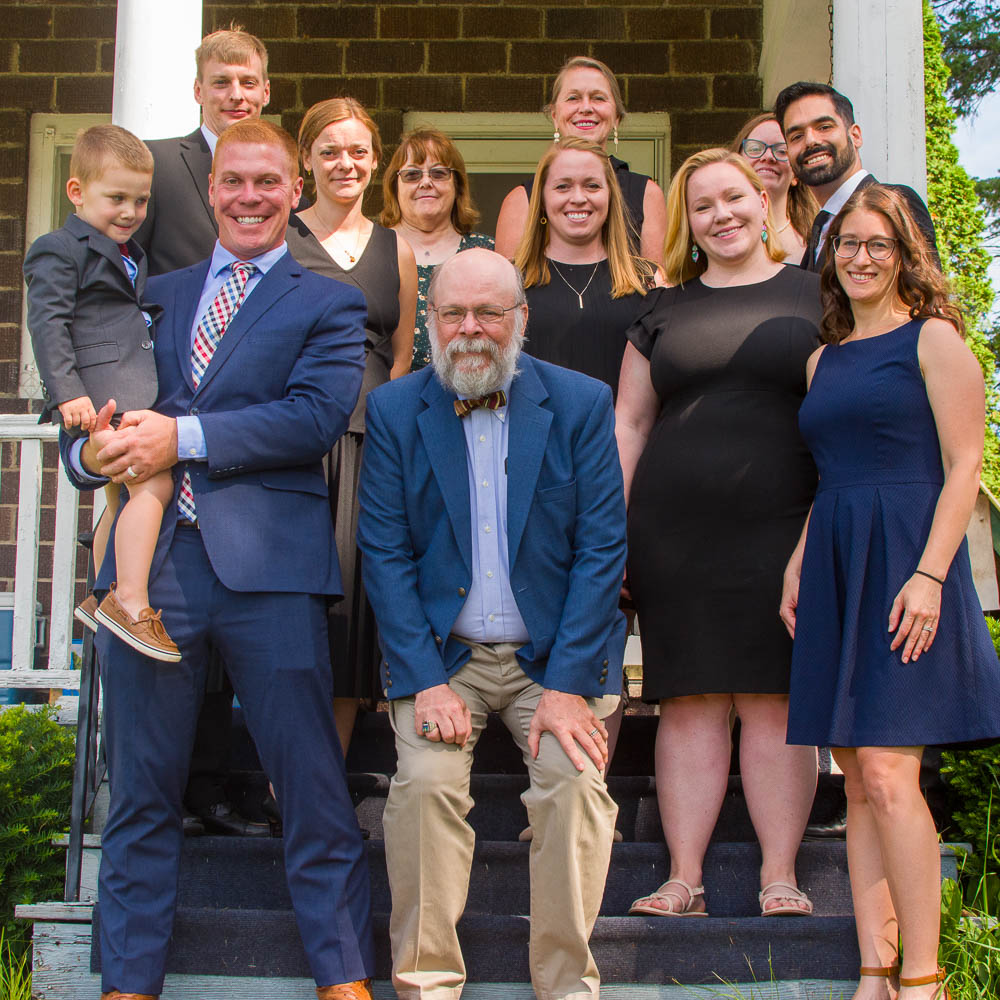 Group photo of Joe Makowiec's family standing on his porch for a farewell photo